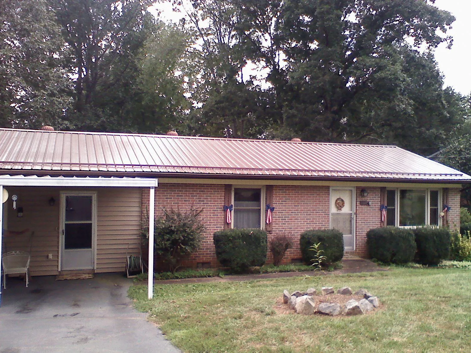 Bronze metal roof and carport on a brick ranch home — Roof Repair work by our crew in West Linn